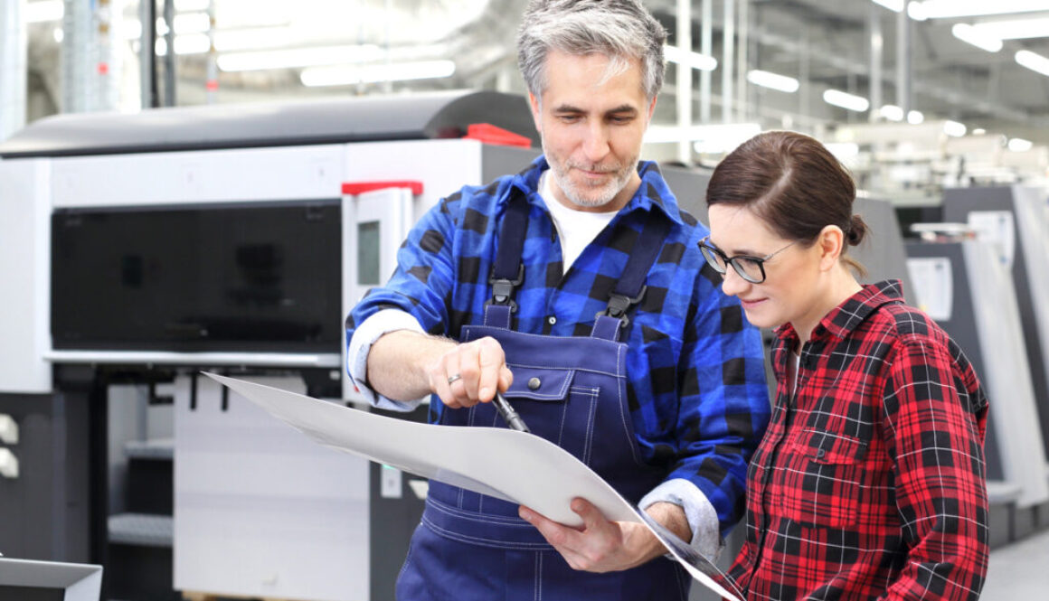 man and woman analyzing printed paper