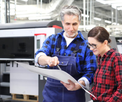 man and woman analyzing printed paper